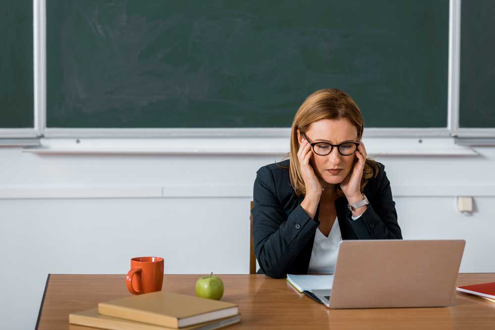 Stressed out teacher in a school