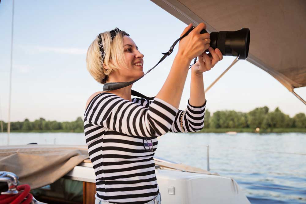 Woman taking a photograph from a boat